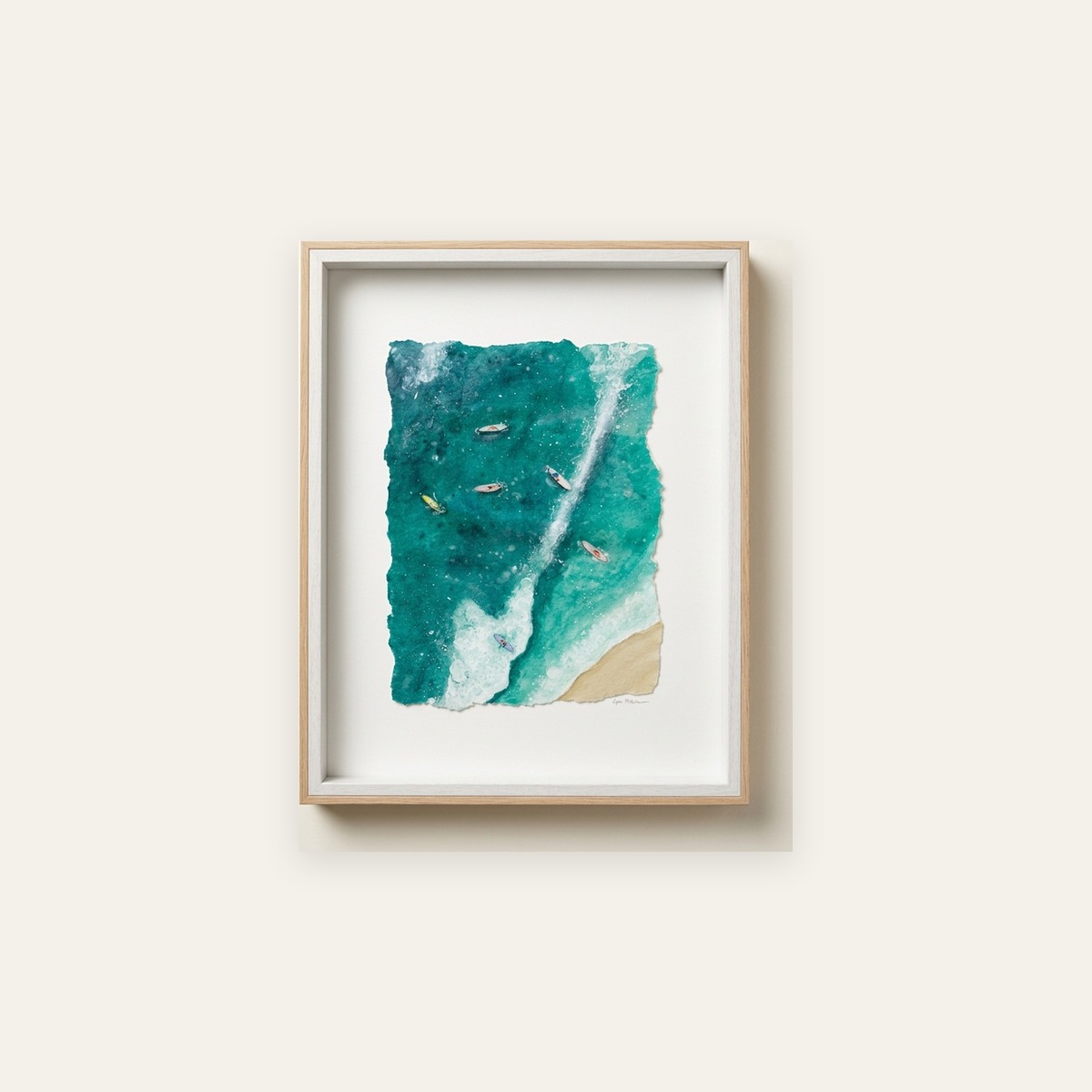 Framed aerial watercolor of surfers paddling through white water toward a sandy shore