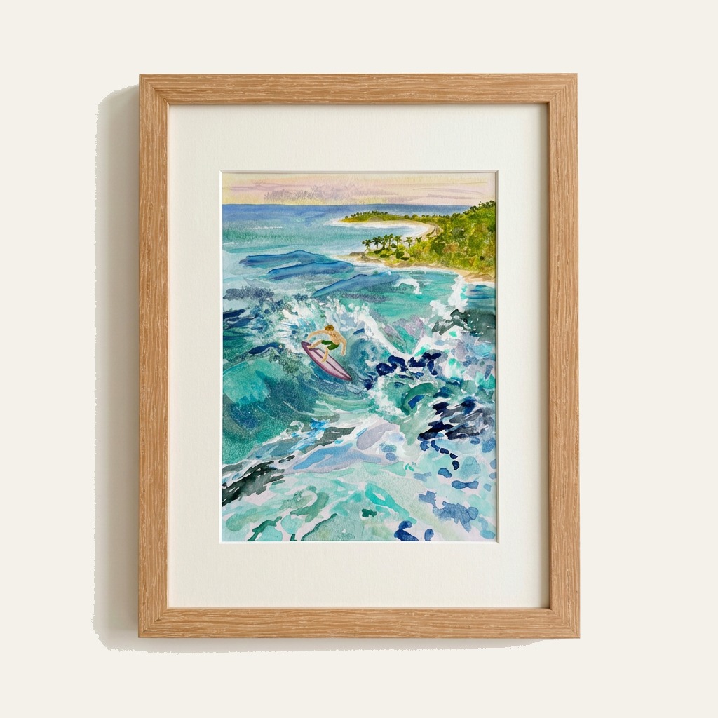 Framed watercolor of a lone surfer riding a turquoise wave near a tropical cove at sunset