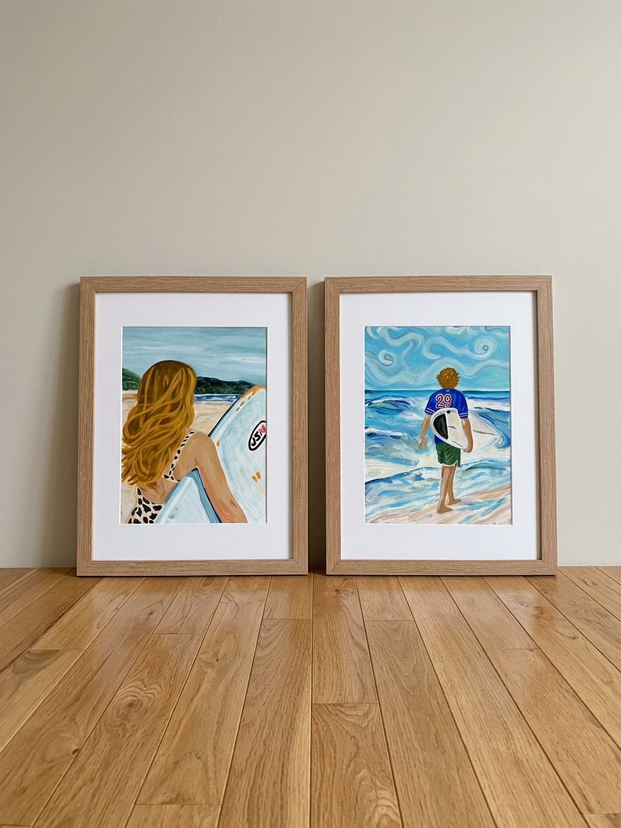 Pair of framed watercolor portraits of surfers walking toward the ocean