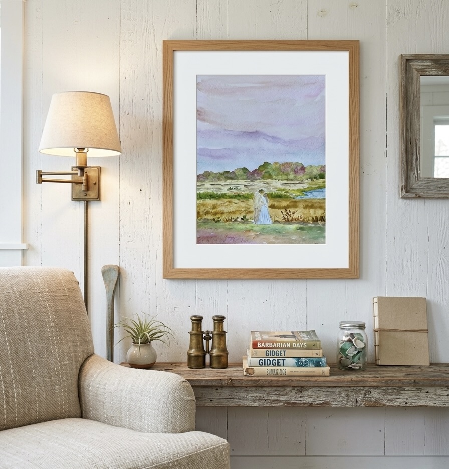Framed watercolor of a couple embracing in a marsh landscape under a lavender sky, hung on white shiplap