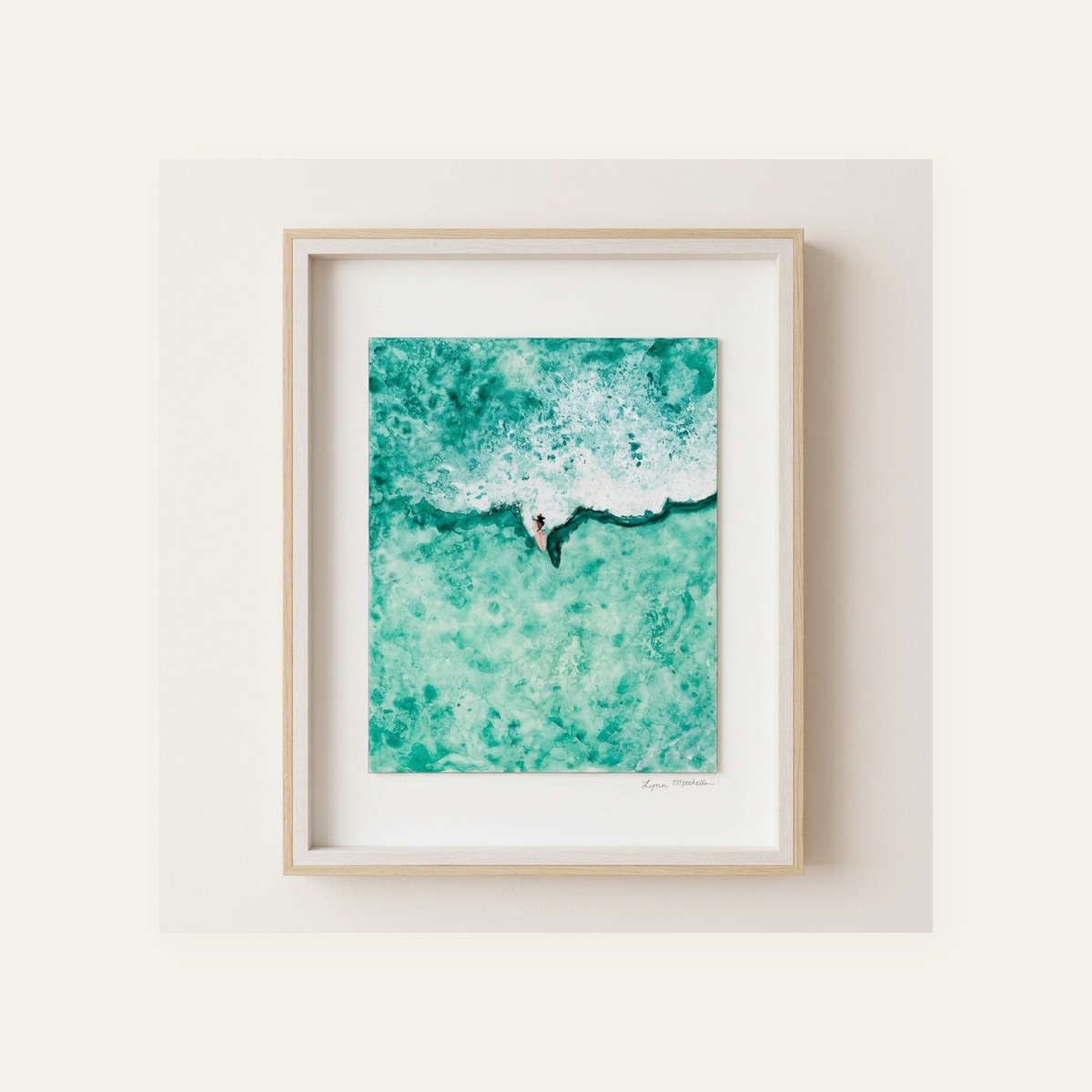 Framed aerial watercolor of a lone surfer paddling through emerald green whitewater